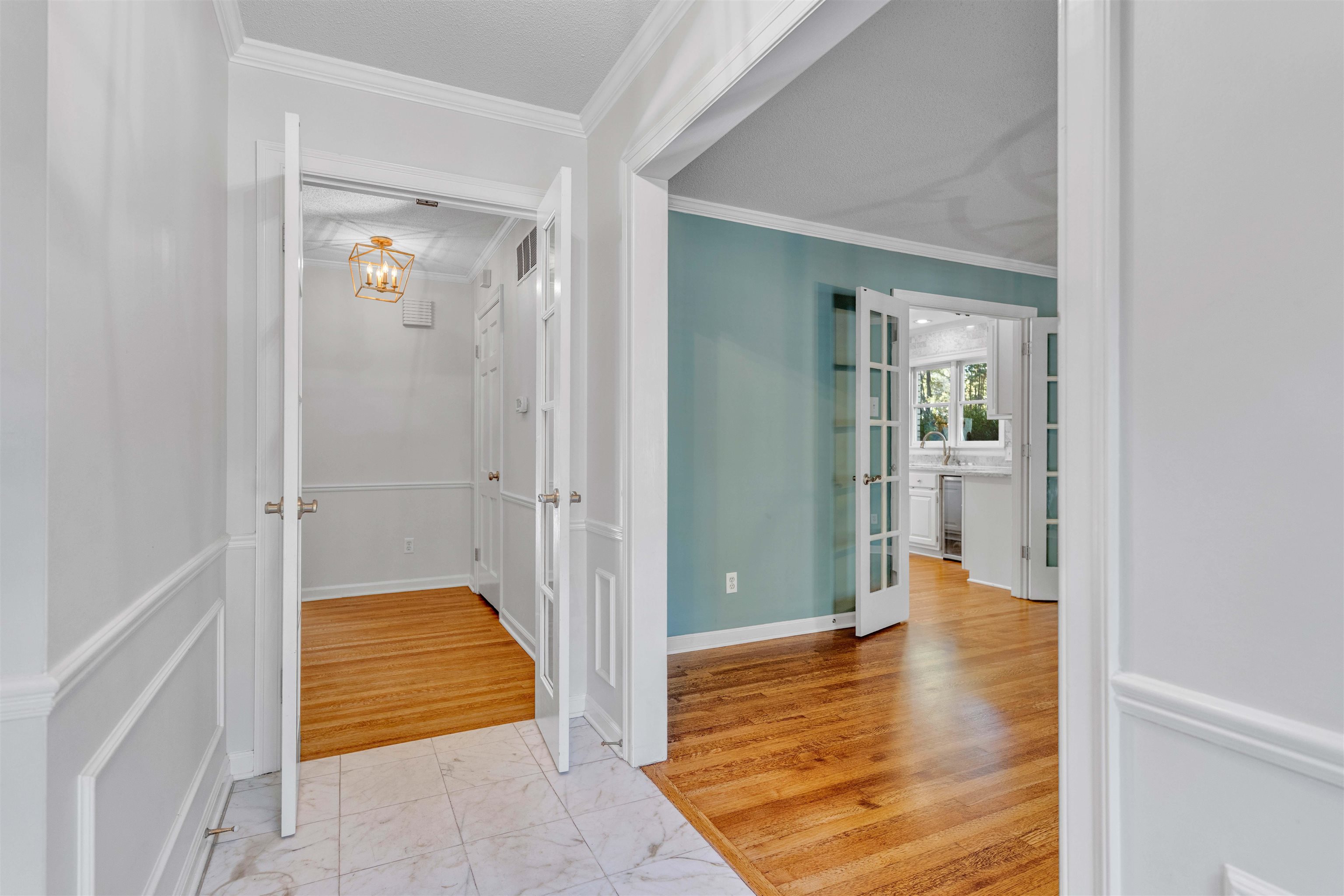 2014 Heather Cove Memphis, TN 38119 - Photo 3 of 40 Corridor featuring crown molding, light marble finish flooring, and a chandelier