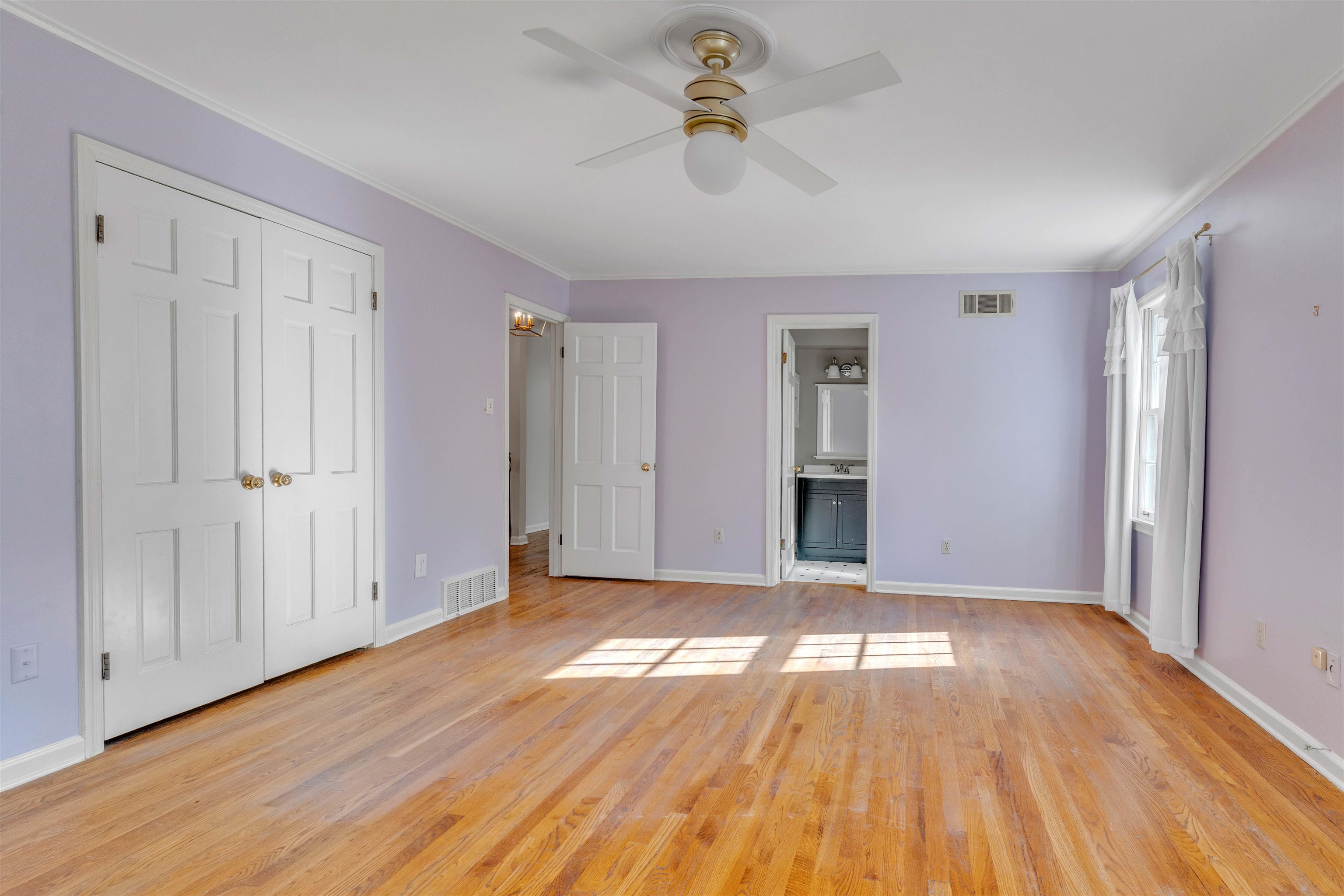 2014 Heather Cove Memphis, TN 38119 - Photo 30 of 40 Unfurnished bedroom featuring light wood-style flooring, a closet, ornamental molding, ceiling fan, and ensuite bathroom