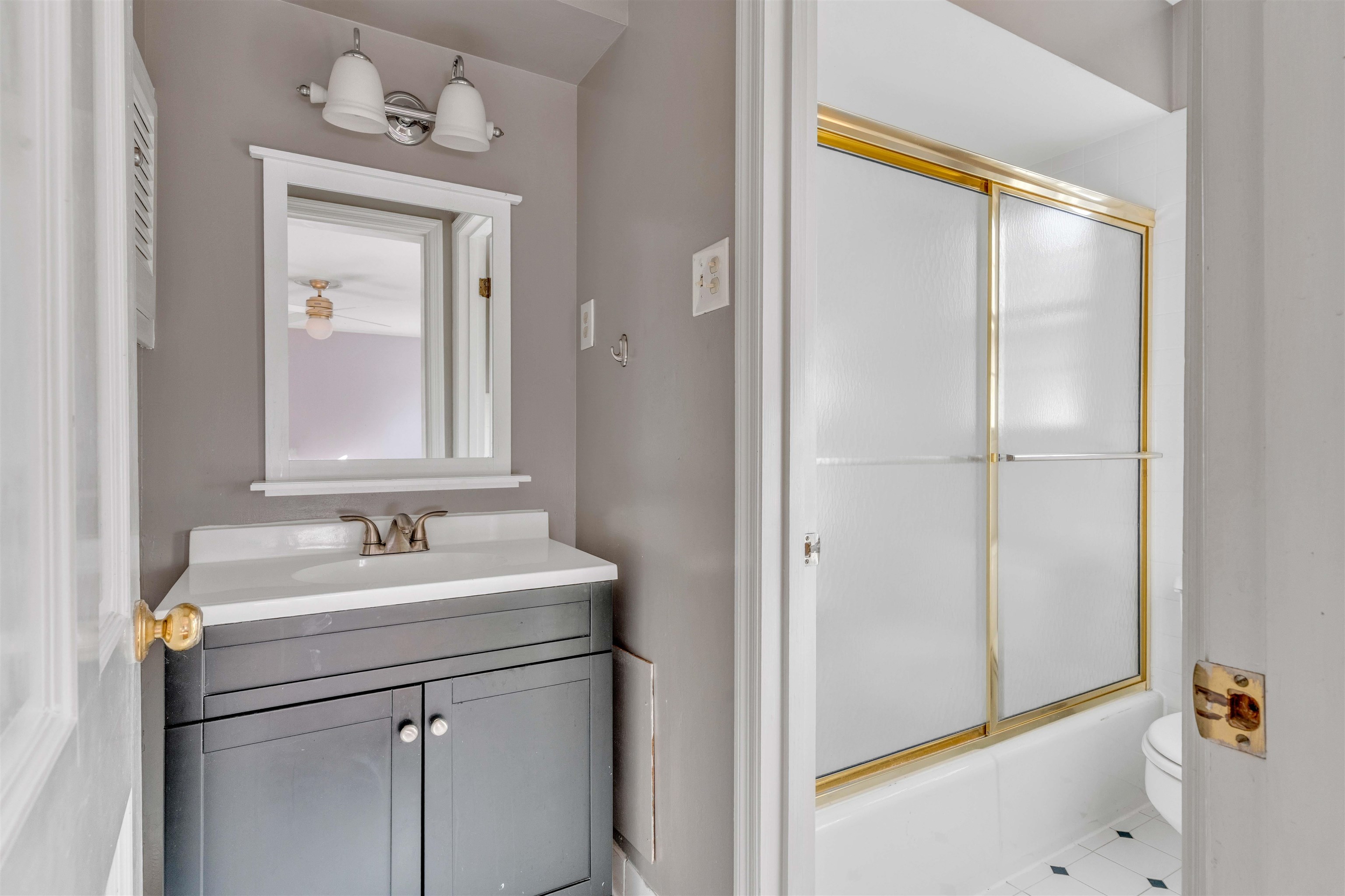 2014 Heather Cove Memphis, TN 38119 - Photo 31 of 40 Bathroom with vanity, enclosed tub / shower combo, and tile patterned flooring