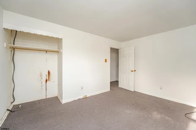 a view of a hallway with seating area