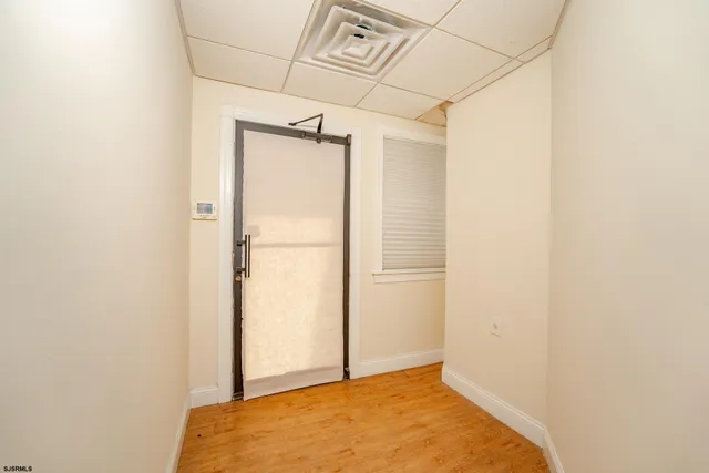 a view of a hallway with a wooden shelves