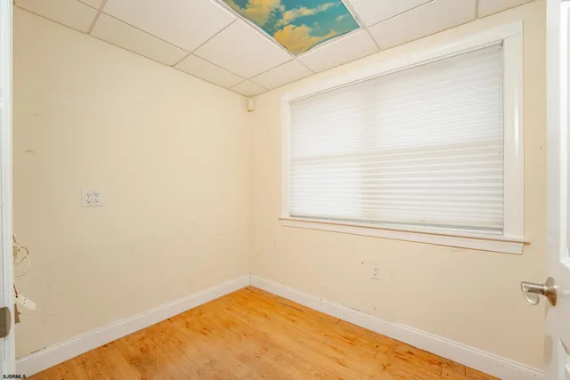 a view of a room with wooden floor