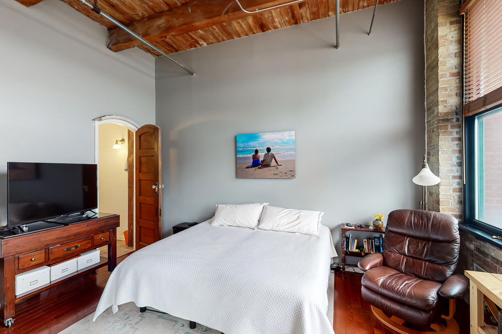 312 North May Street, Unit 3F Chicago, IL 60607 - Photo 15 of 22 a bedroom with furniture and a flat screen tv