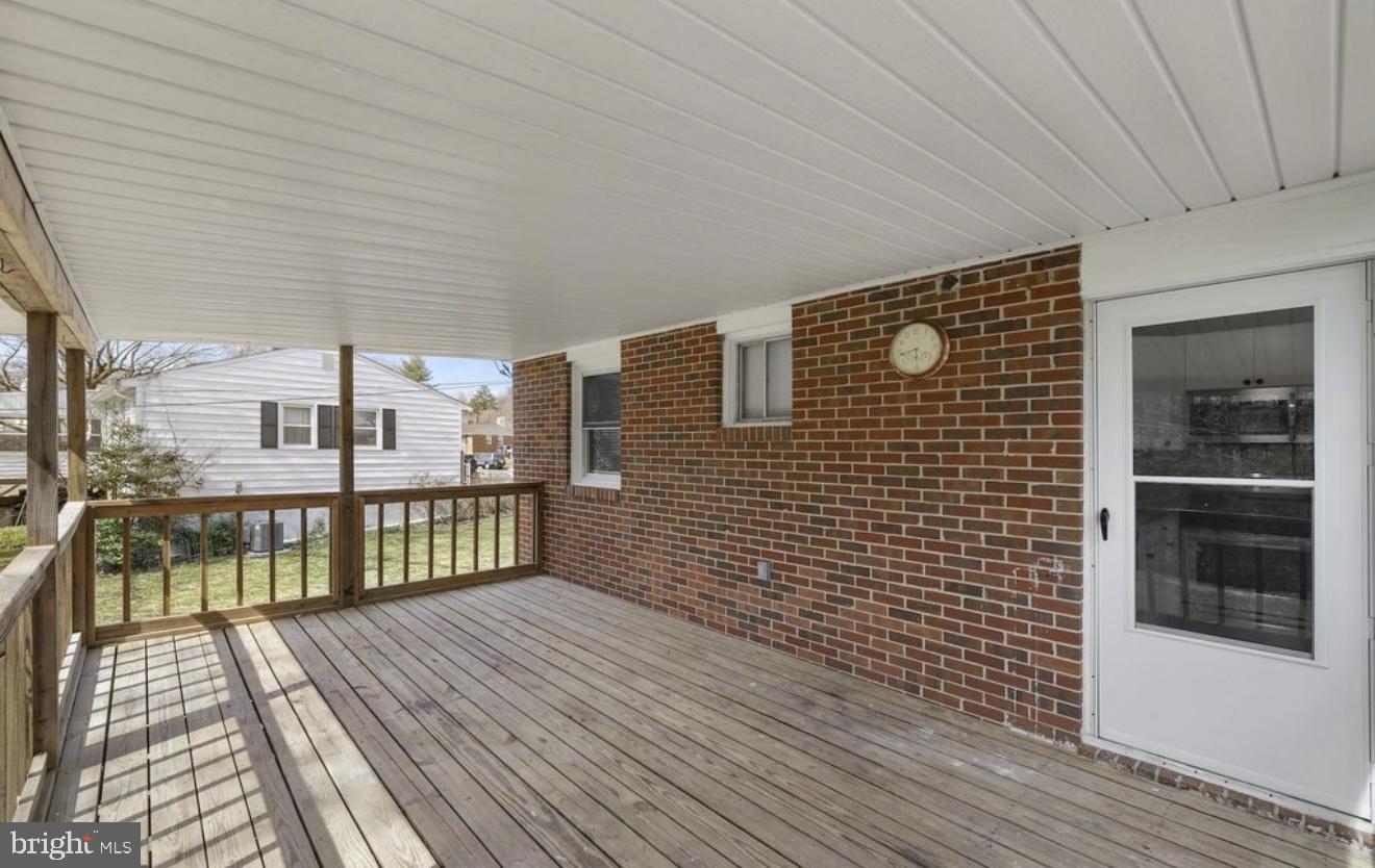 243 Highmeadow Road Reisterstown, MD 21136 - Photo 6 of 32 Spacious deck with charming brick backdrop.