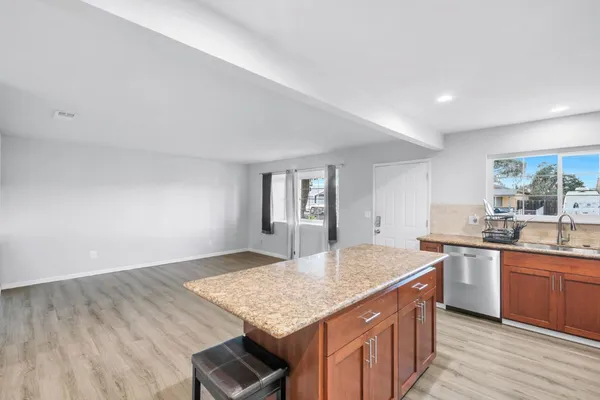 a kitchen with stainless steel appliances granite countertop a sink stove and cabinets
