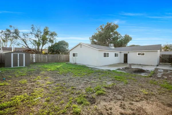 a view of a house with yard and a tree