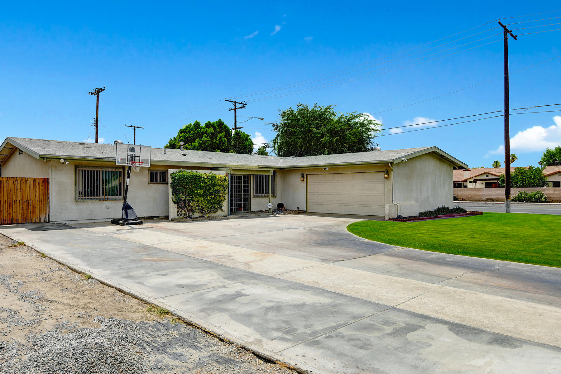 44952 Windsor Drive Indio, CA 92201 - Photo 1 of 24 a front view of a house with a yard and garage