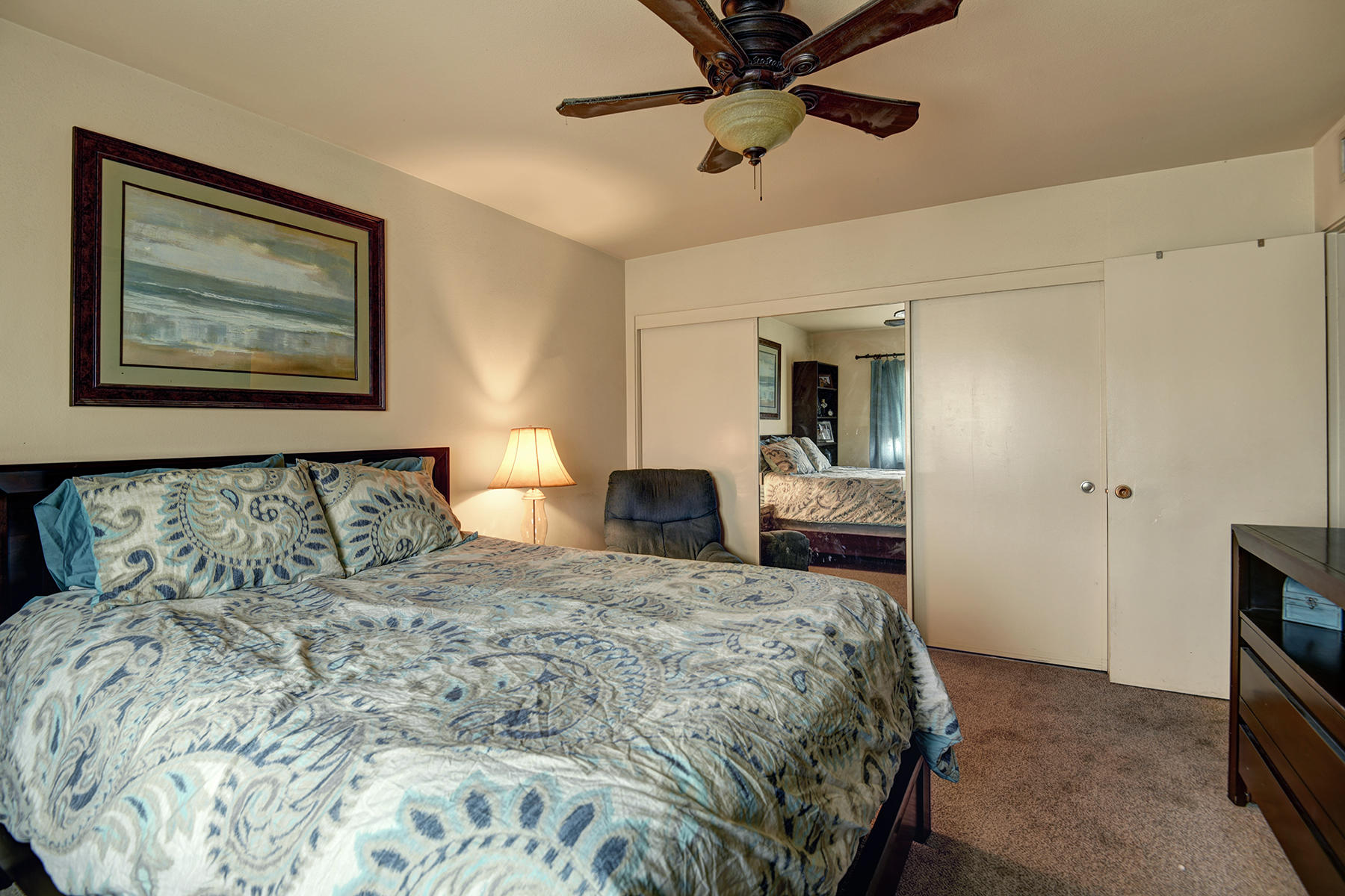 44952 Windsor Drive Indio, CA 92201 - Photo 13 of 24 a bedroom with a large bed and a chandelier