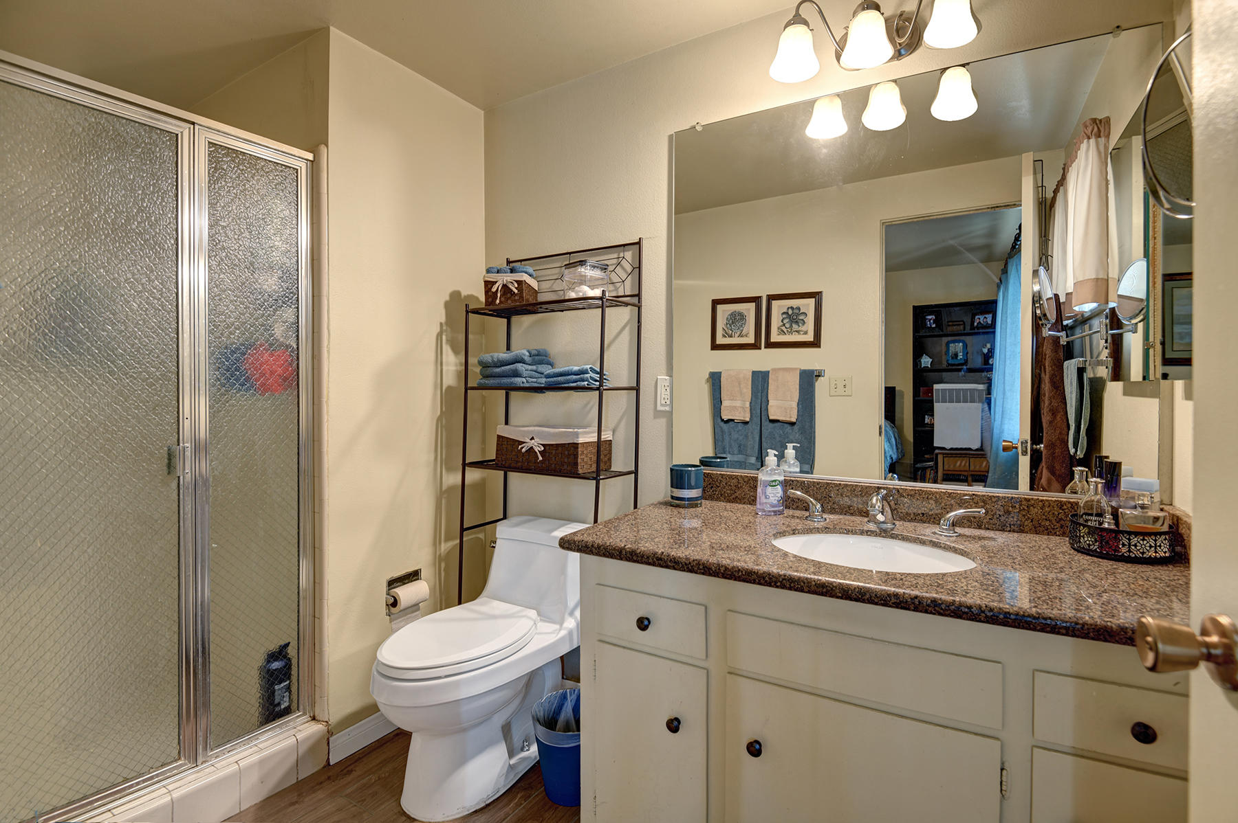 44952 Windsor Drive Indio, CA 92201 - Photo 15 of 24 a bathroom with a toilet a sink and a large mirror