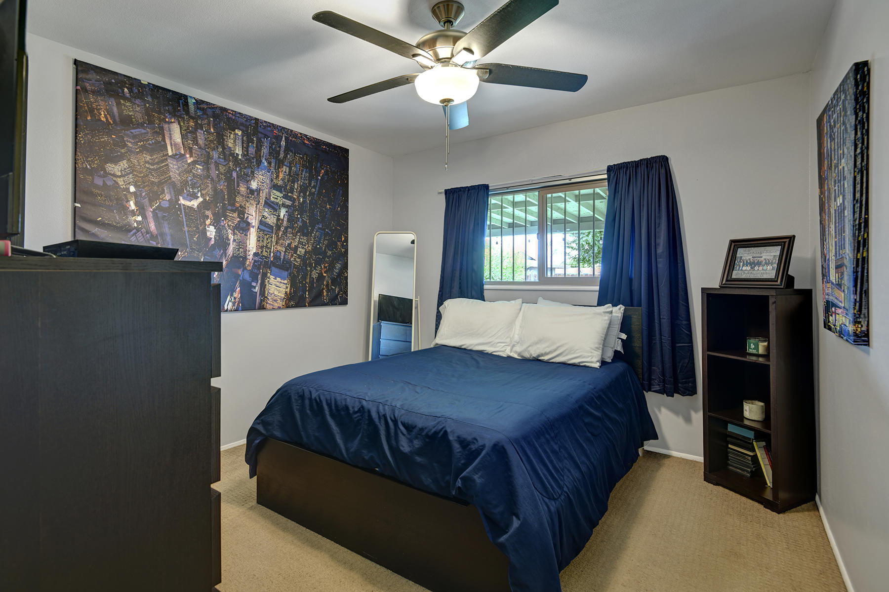 44952 Windsor Drive Indio, CA 92201 - Photo 16 of 24 a bedroom with a bed and a chandelier