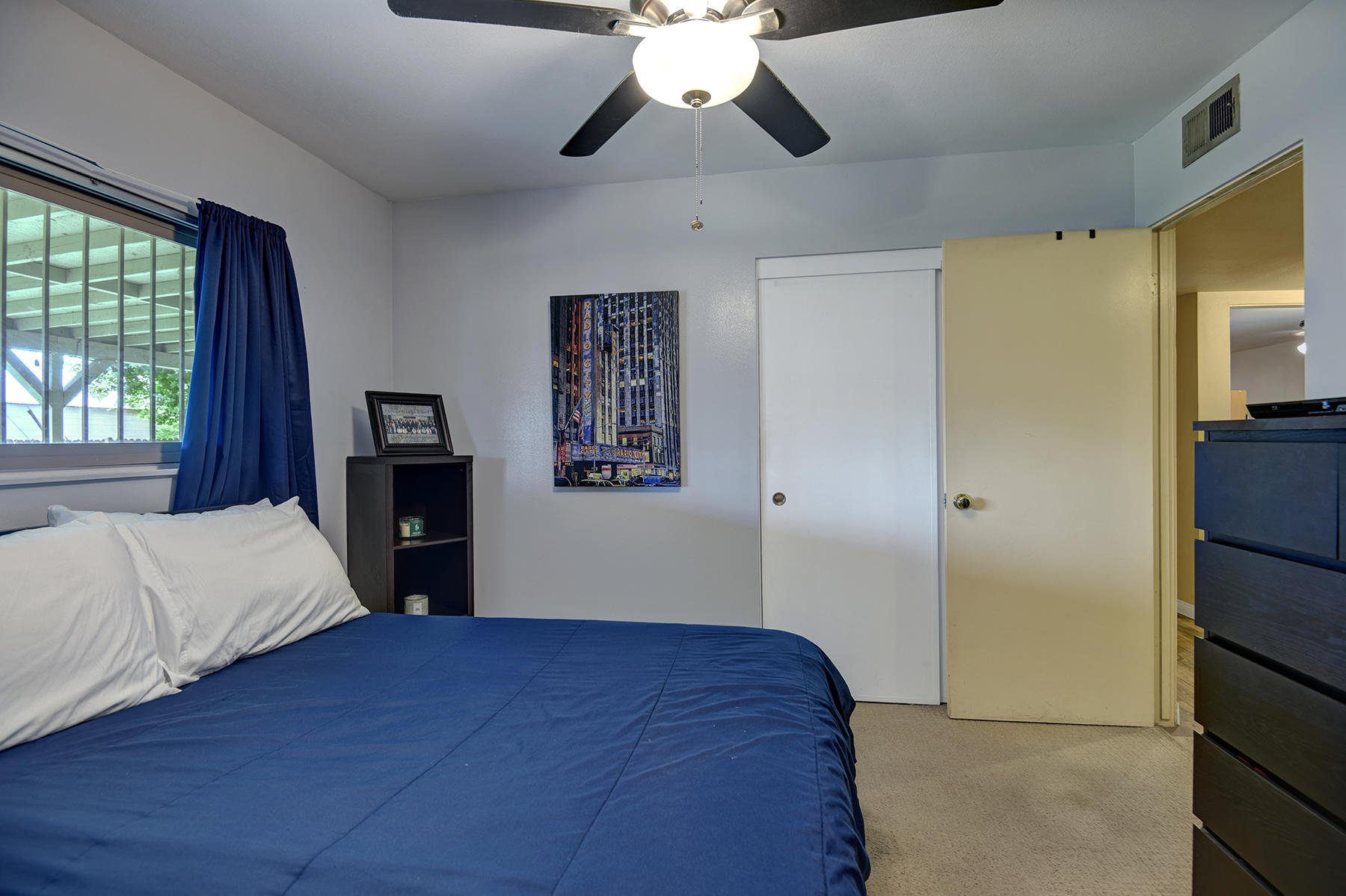 44952 Windsor Drive Indio, CA 92201 - Photo 17 of 24 a bedroom with a bed and a chandelier