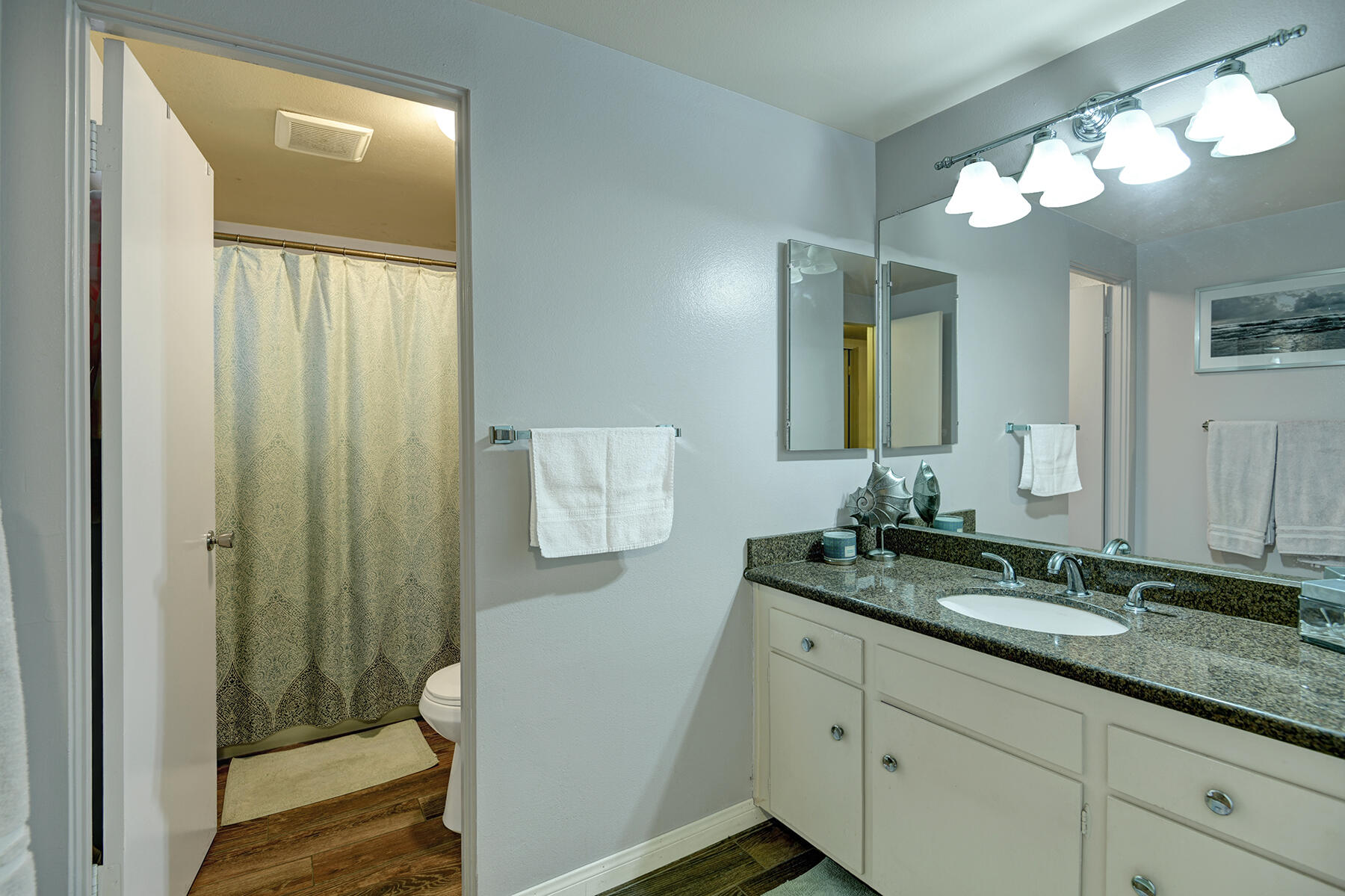 44952 Windsor Drive Indio, CA 92201 - Photo 19 of 24 a bathroom with a granite countertop sink a mirror and a shower