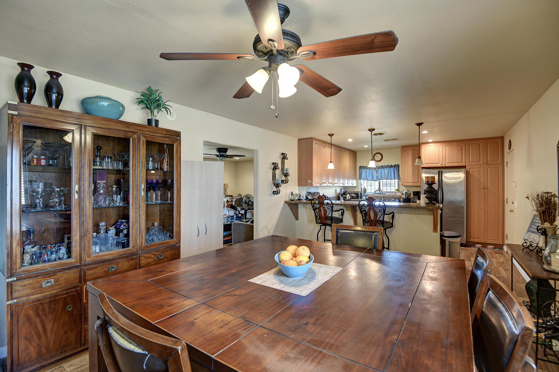 44952 Windsor Drive Indio, CA 92201 - Photo 4 of 24 a view of a dining room and livingroom with furniture wooden floor a chandelier