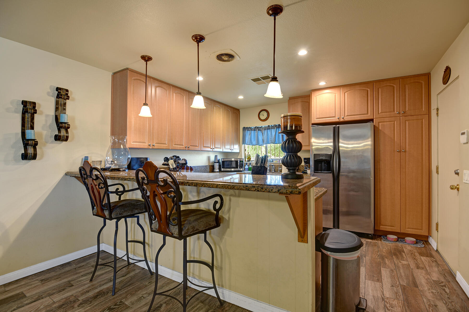 44952 Windsor Drive Indio, CA 92201 - Photo 6 of 24 a kitchen with stainless steel appliances granite countertop a refrigerator a stove a sink dishwasher with a dining table and chairs