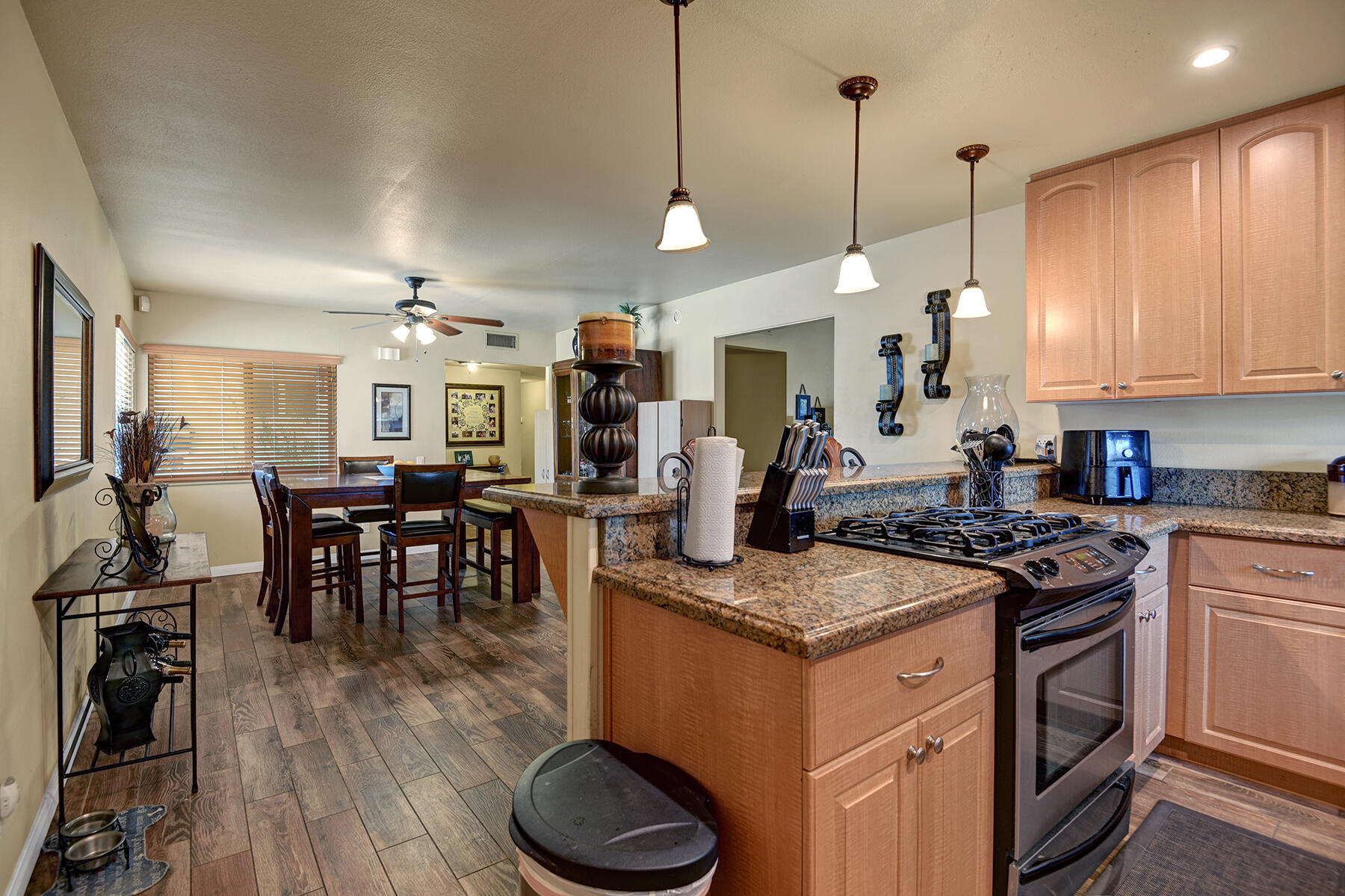 44952 Windsor Drive Indio, CA 92201 - Photo 7 of 24 a kitchen that has a lot of cabinets in it and wooden floors