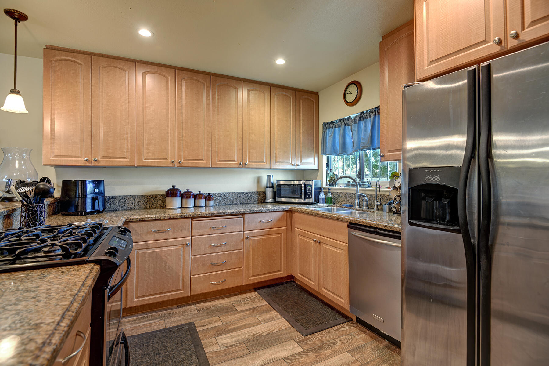 44952 Windsor Drive Indio, CA 92201 - Photo 8 of 24 a kitchen with stainless steel appliances granite countertop a stove a sink and a refrigerator