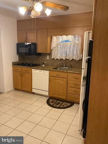 a kitchen with a refrigerator and a sink