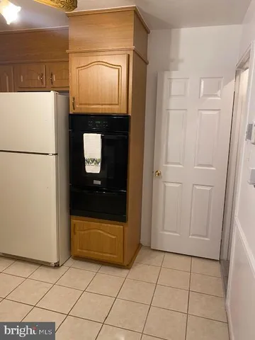 a kitchen with a sink a stove top oven a counter top space and cabinets
