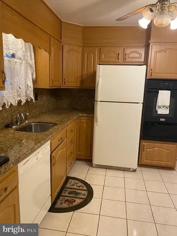 a kitchen with a refrigerator a stove a microwave and a counter top space