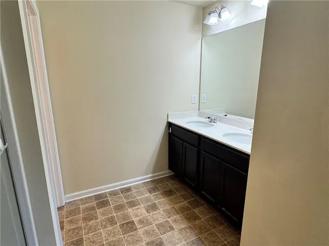 a room with a sink and a mirror