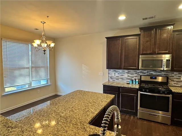 a kitchen that has a stove and a refrigerator