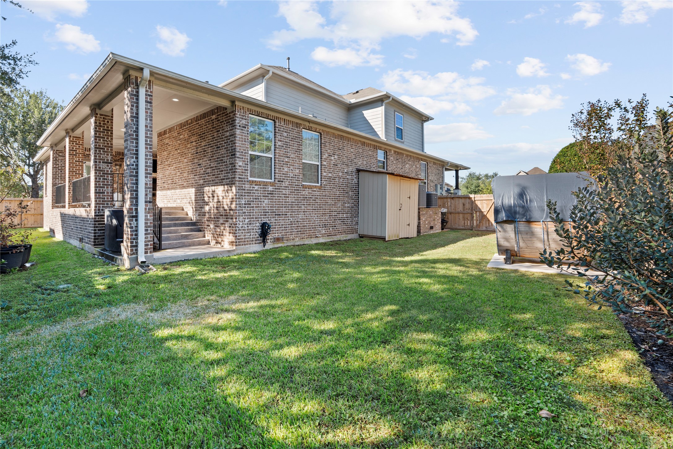 6207 Graff Net Court Spring, TX 77379 - Photo 44 of 49 Charming raised patio with stairs that flow seamlessly into the yard.