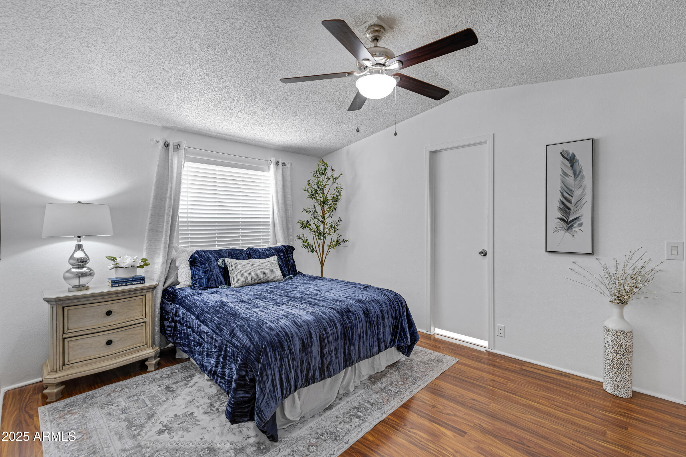 834 South Meridian Road, Unit 164 Apache Junction, AZ 85120 - Photo 11 of 16 a bedroom with a large bed and a chandelier