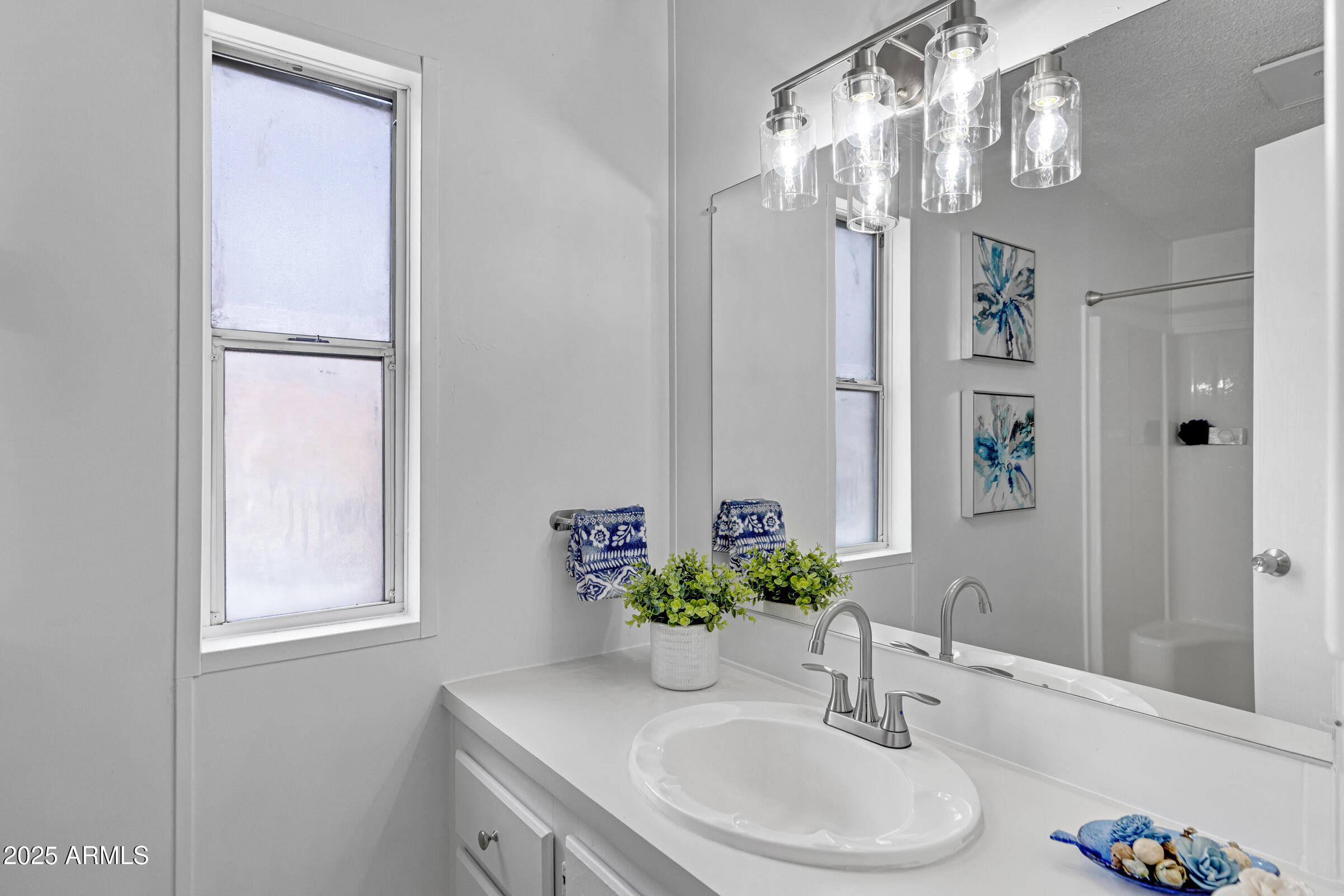 834 South Meridian Road, Unit 164 Apache Junction, AZ 85120 - Photo 12 of 16 a bathroom with a sink a vanity and a mirror