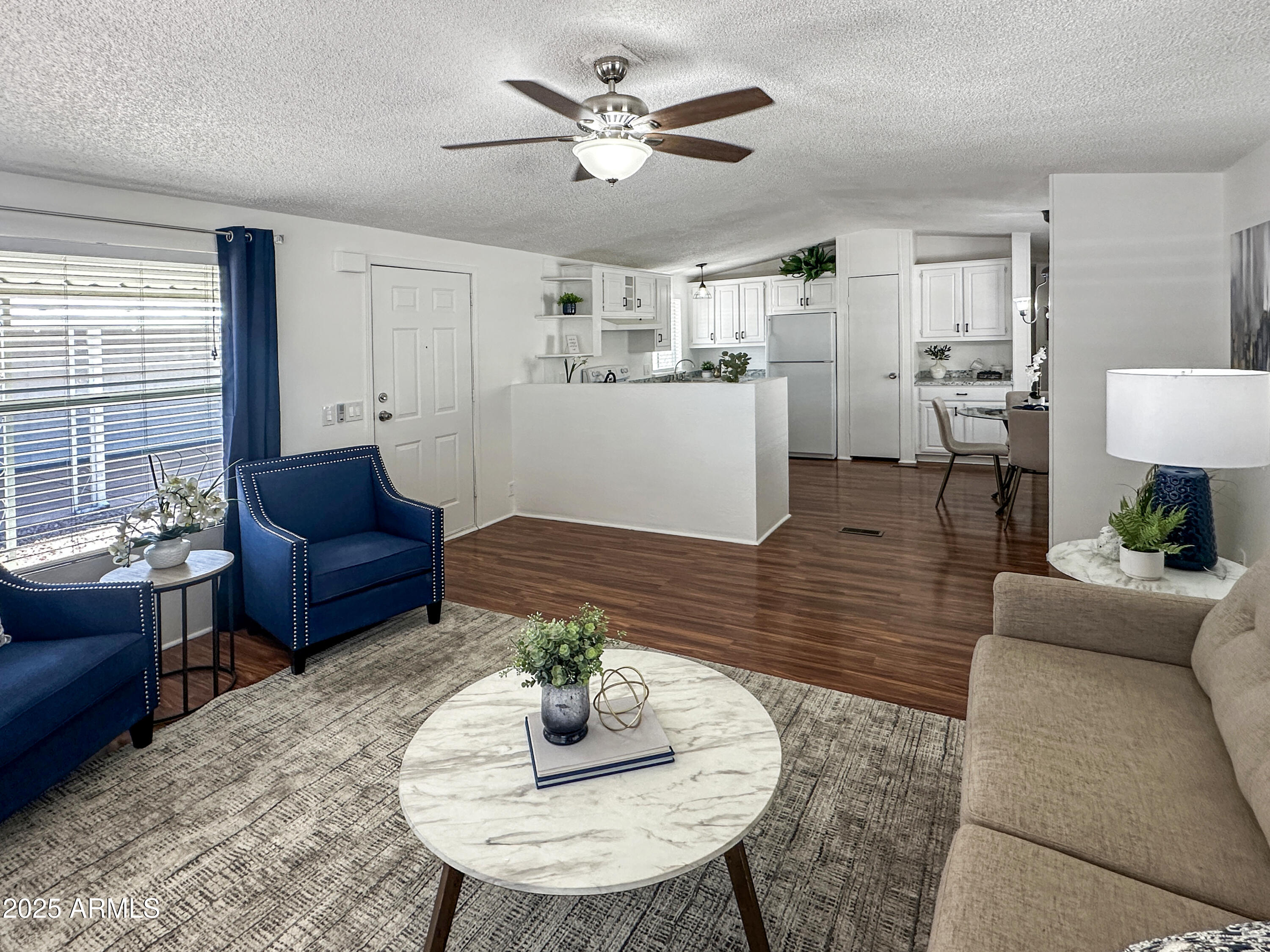 834 South Meridian Road, Unit 164 Apache Junction, AZ 85120 - Photo 3 of 16 a living room with furniture kitchen view and a table