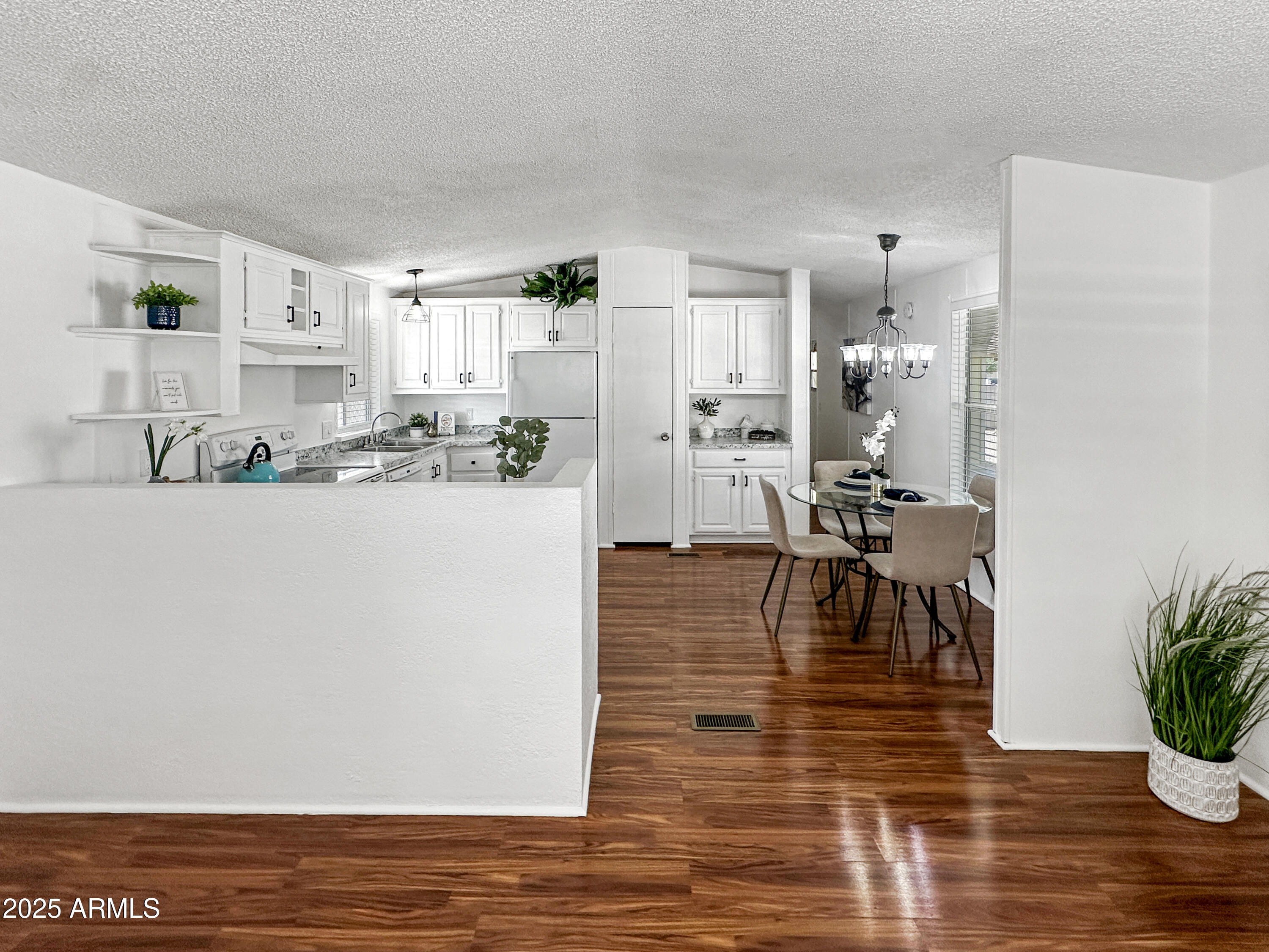 834 South Meridian Road, Unit 164 Apache Junction, AZ 85120 - Photo 4 of 16 a dining room with furniture and wooden floor