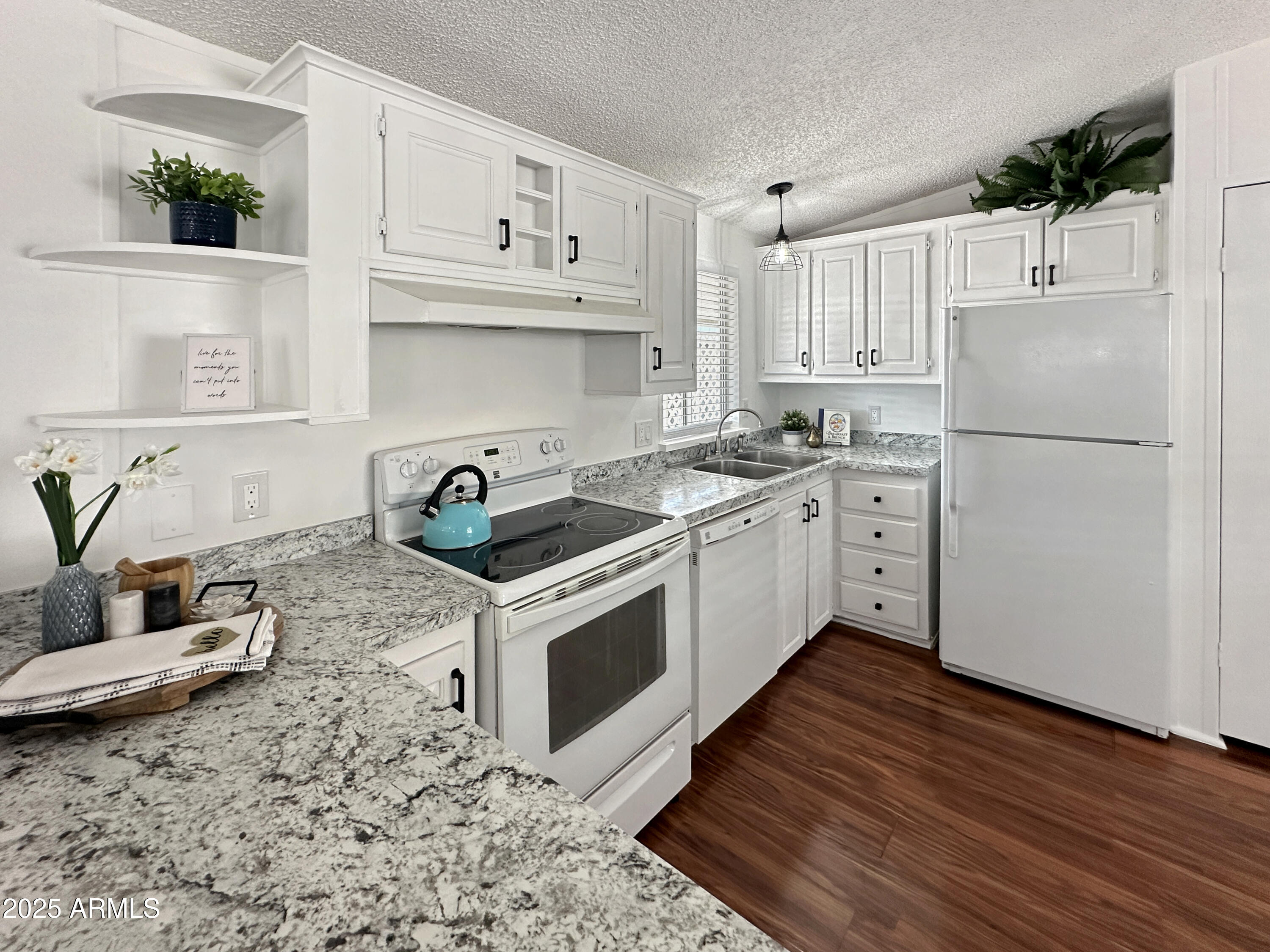834 South Meridian Road, Unit 164 Apache Junction, AZ 85120 - Photo 5 of 16 a kitchen with stainless steel appliances granite countertop a sink a stove a refrigerator and cabinets