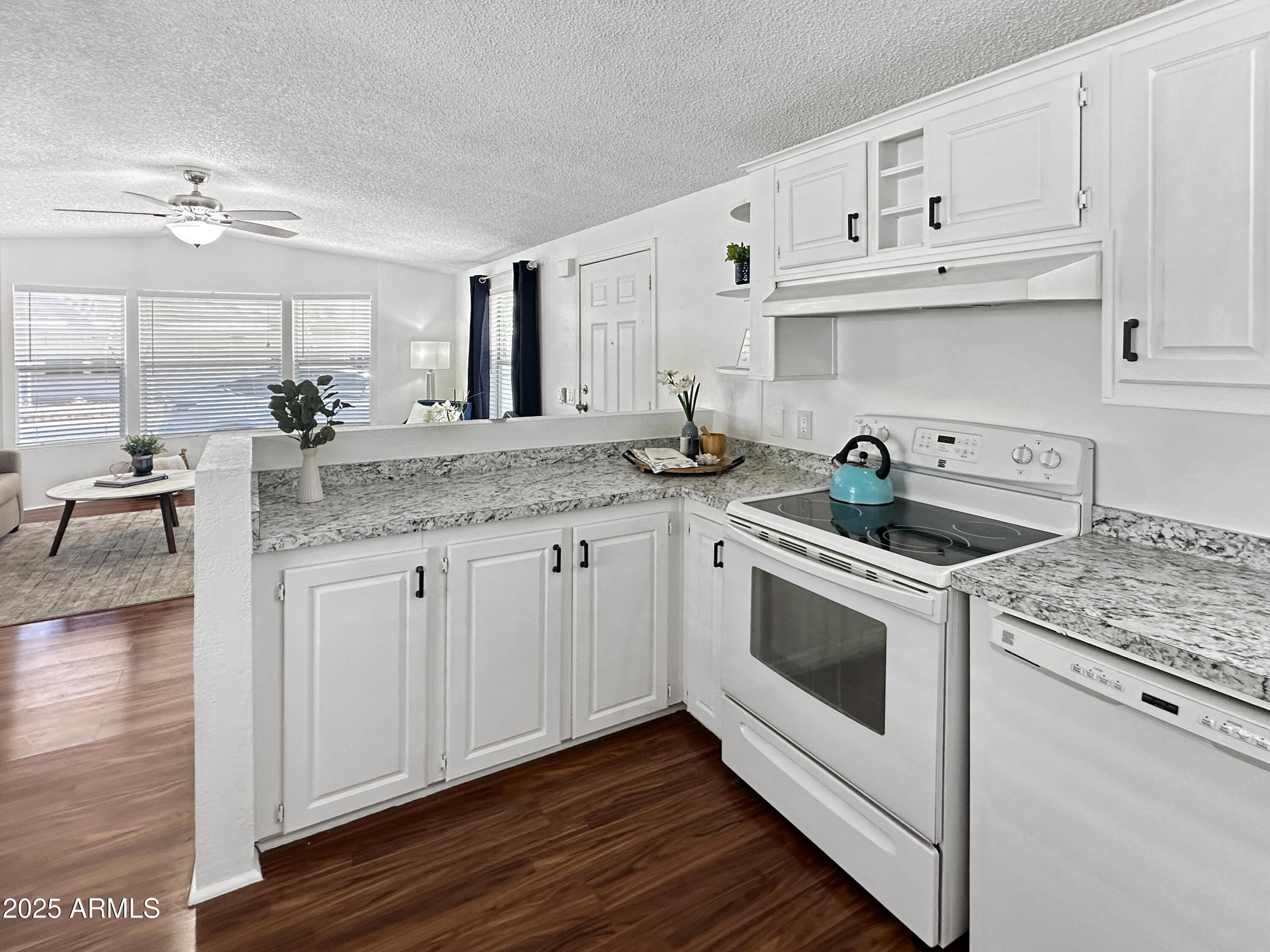 834 South Meridian Road, Unit 164 Apache Junction, AZ 85120 - Photo 6 of 16 a kitchen with granite countertop white cabinets and white appliances