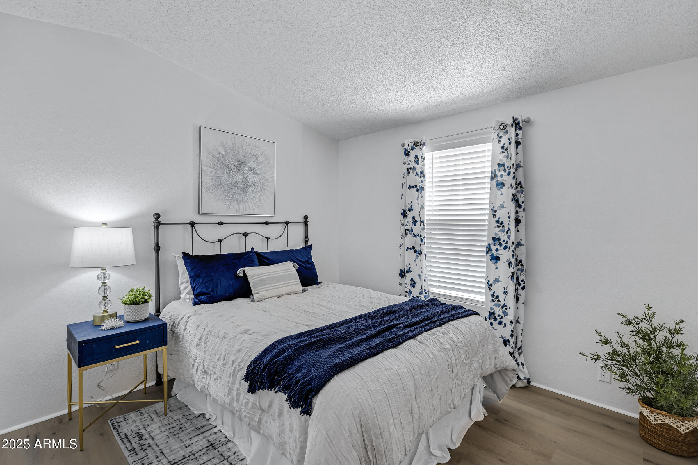 834 South Meridian Road, Unit 164 Apache Junction, AZ 85120 - Photo 8 of 16 a bedroom with a bed and a potted plant on the dresser