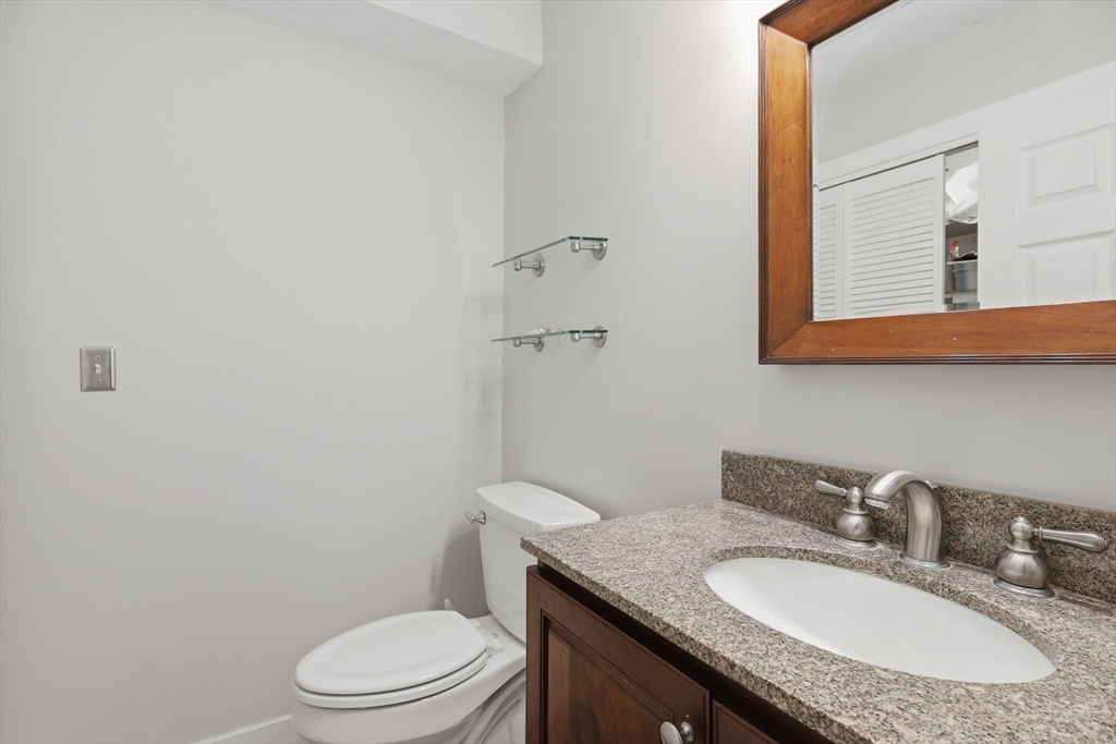 68 South Quinsigamond Avenue, Unit 4 Shrewsbury, MA 01545 - Photo 15 of 37 a bathroom with a granite countertop sink a toilet and a mirror