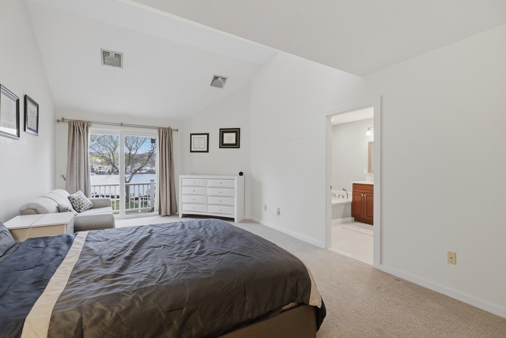 68 South Quinsigamond Avenue, Unit 4 Shrewsbury, MA 01545 - Photo 20 of 37 a spacious bedroom with a bed a couch and a window