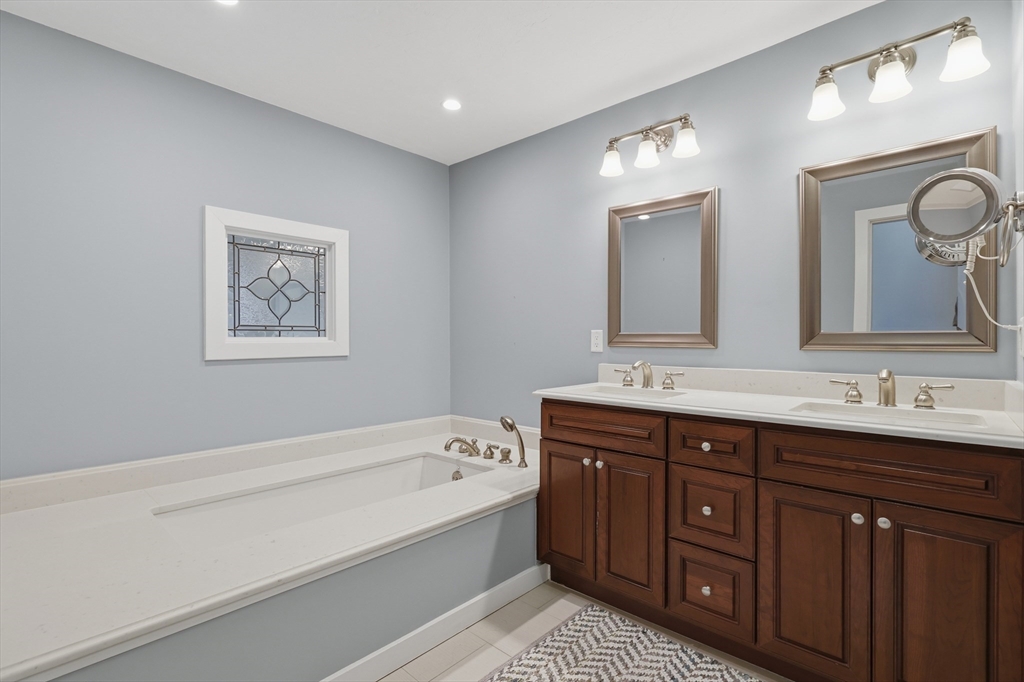 68 South Quinsigamond Avenue, Unit 4 Shrewsbury, MA 01545 - Photo 22 of 37 a spacious bathroom with a tub double sink and mirror