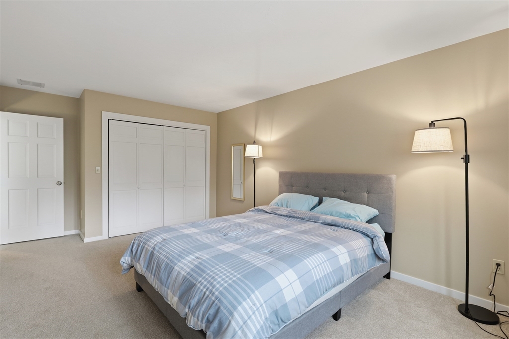 68 South Quinsigamond Avenue, Unit 4 Shrewsbury, MA 01545 - Photo 24 of 37 a bedroom with a bed and a lamp