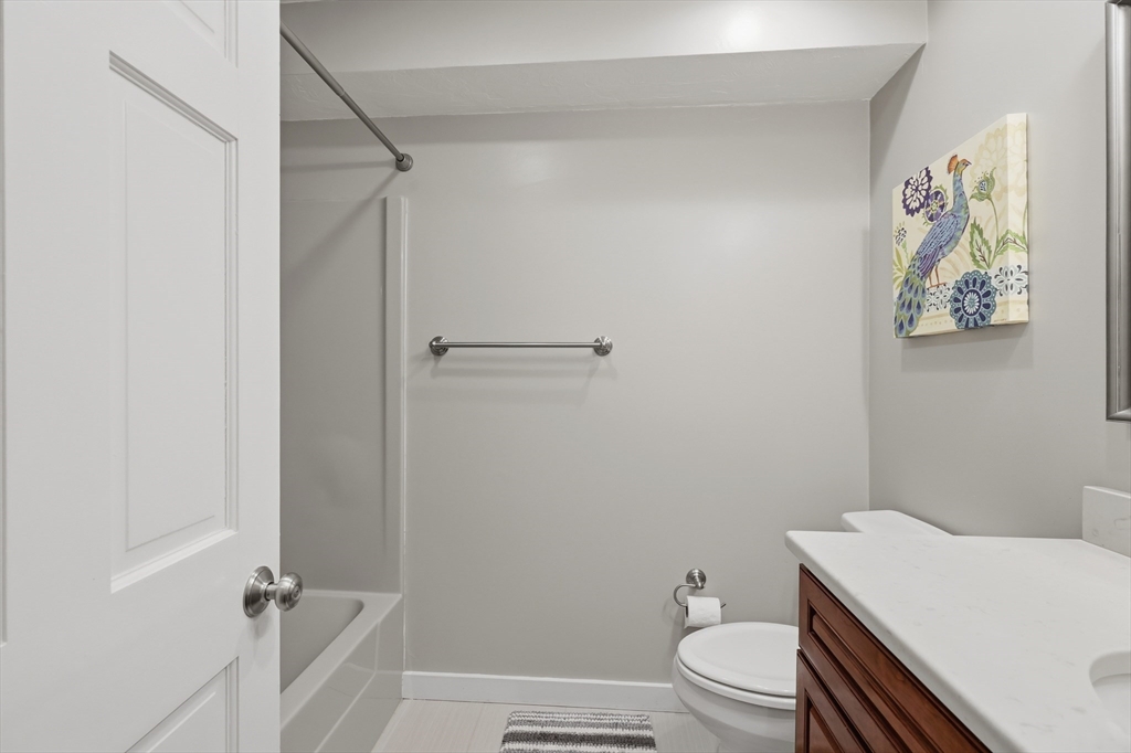 68 South Quinsigamond Avenue, Unit 4 Shrewsbury, MA 01545 - Photo 25 of 37 a bathroom with a granite countertop sink toilet and a shower