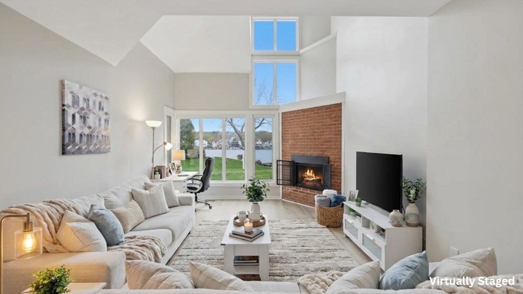 68 South Quinsigamond Avenue, Unit 4 Shrewsbury, MA 01545 - Photo 6 of 37 a living room with furniture a flat screen tv and a fireplace