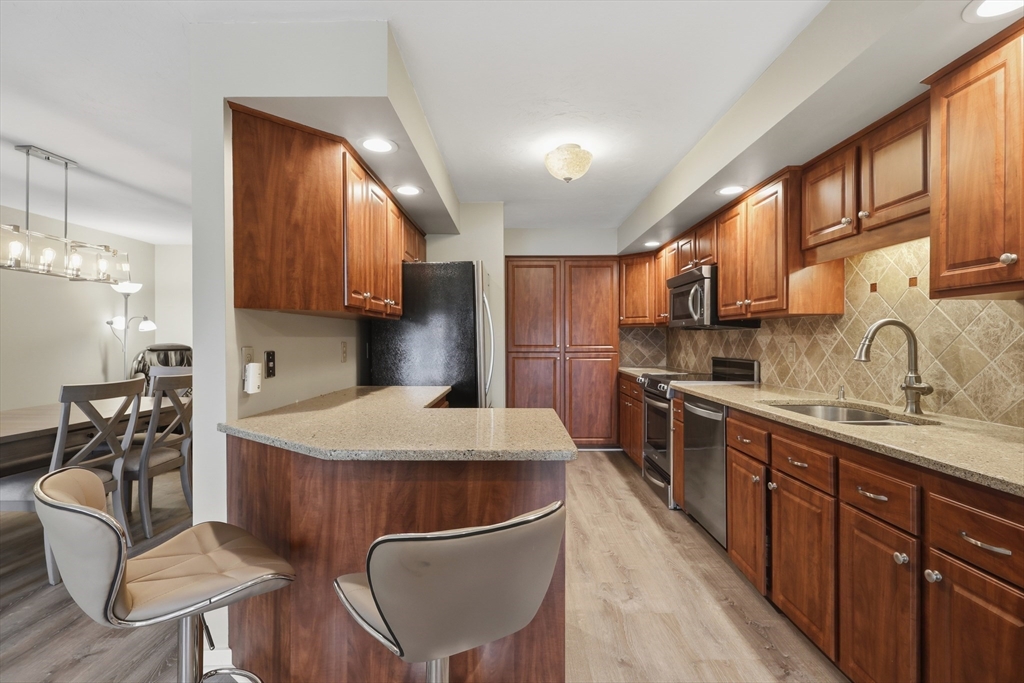 68 South Quinsigamond Avenue, Unit 4 Shrewsbury, MA 01545 - Photo 9 of 37 a kitchen with stainless steel appliances granite countertop a sink refrigerator and cabinets