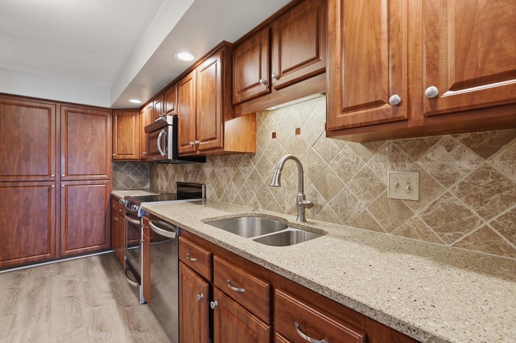 68 South Quinsigamond Avenue, Unit 4 Shrewsbury, MA 01545 - Photo 10 of 37 a kitchen with stainless steel appliances granite countertop a sink a refrigerator and cabinets