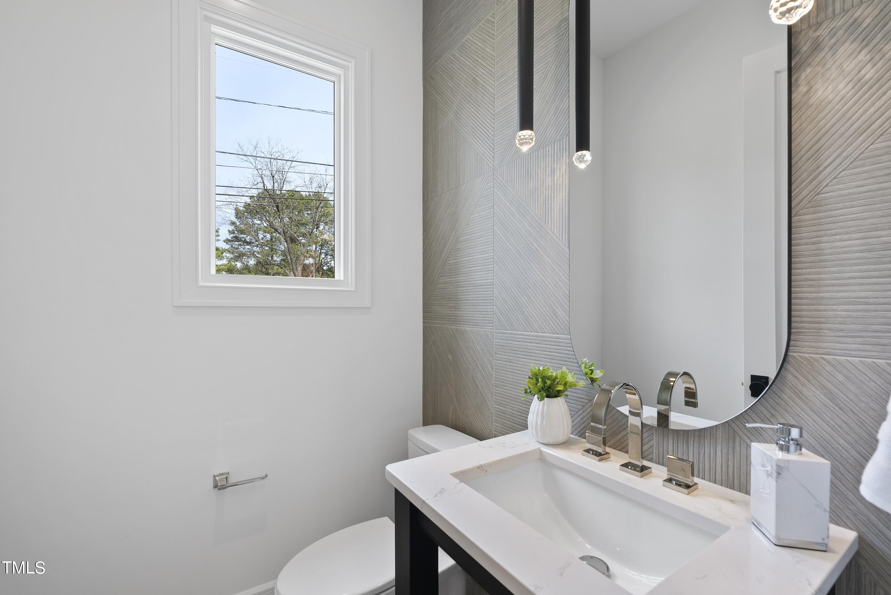 100 East Rowan Street Raleigh, NC 27609 - Photo 38 of 58 a bathroom with a sink a toilet and a mirror