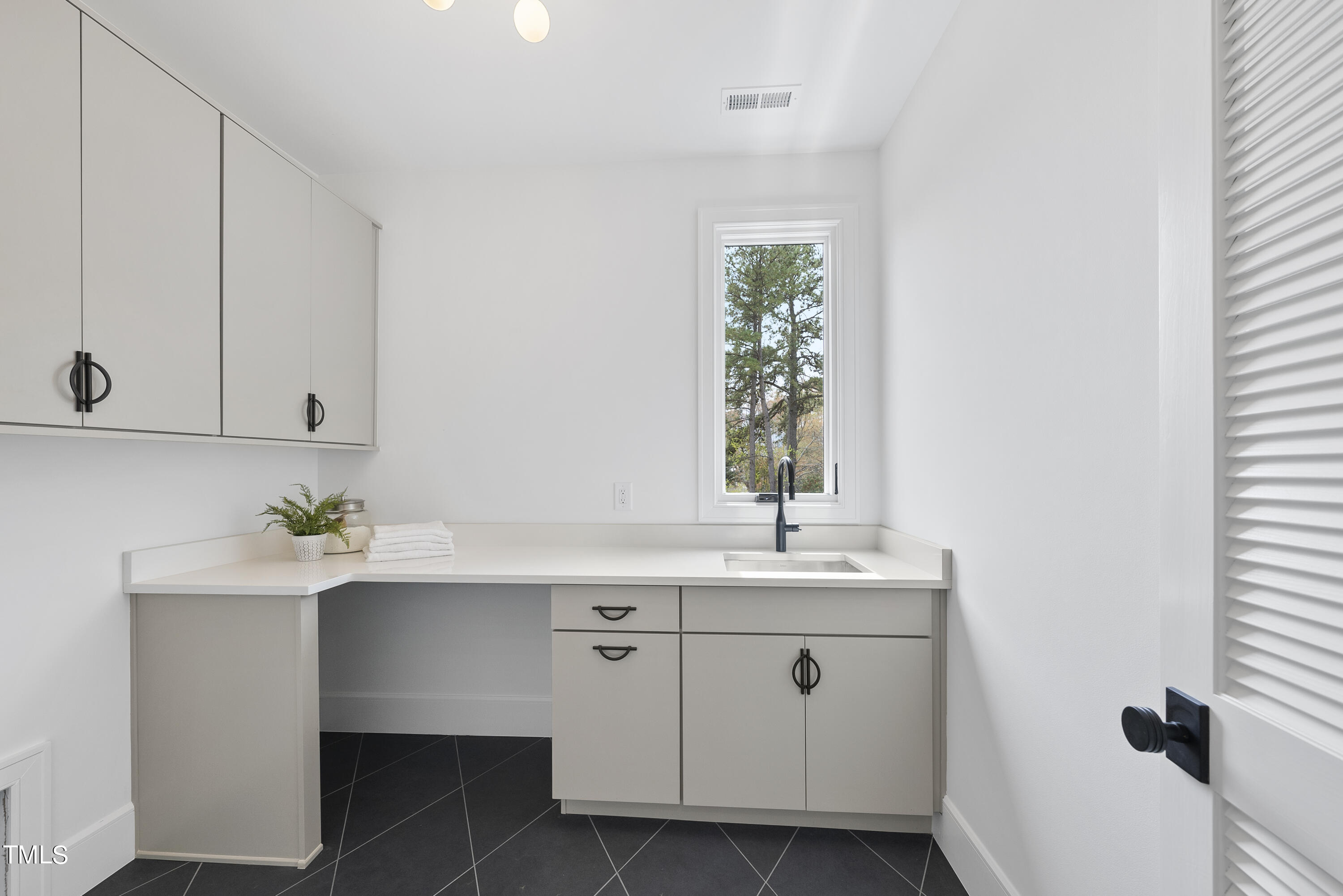100 East Rowan Street Raleigh, NC 27609 - Photo 42 of 58 a kitchen with a sink cabinets and window