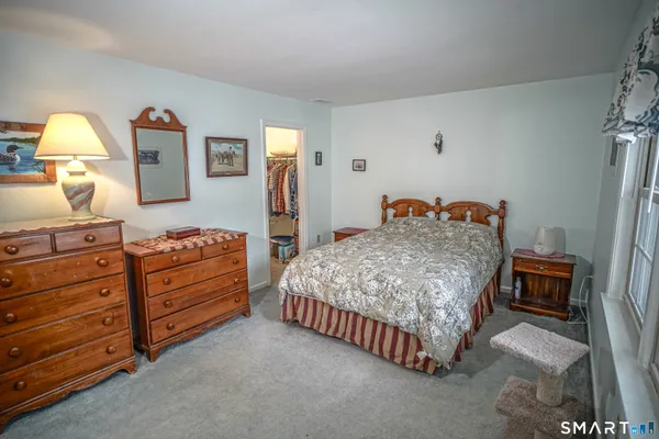 a bedroom with a bed and a dresser in it