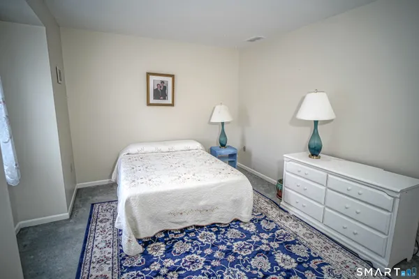 a bed room with a bed and a lamp