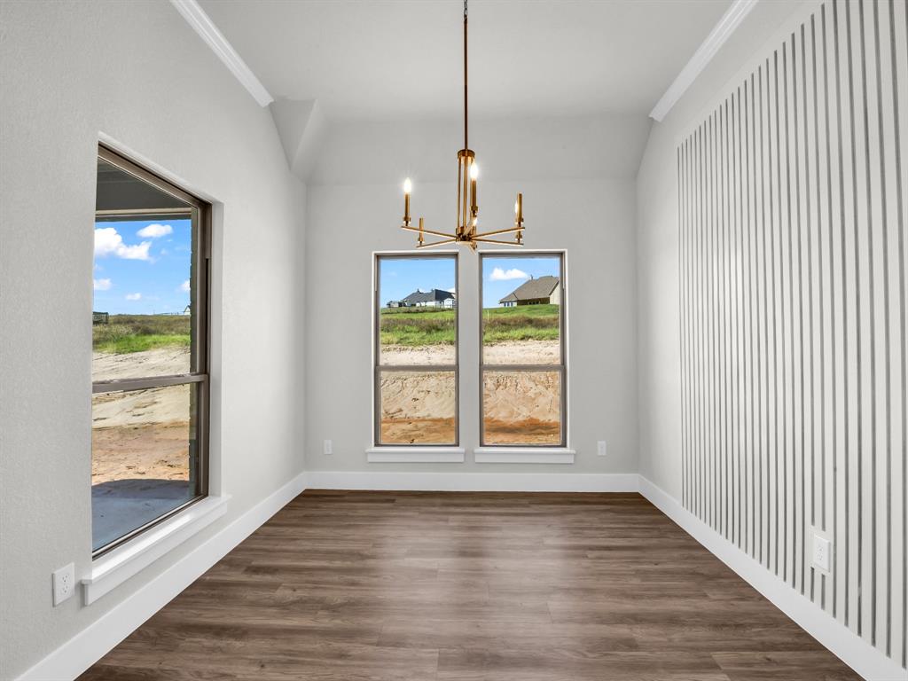 3025 West Frk Way Springtown, TX 76082 - Photo 11 of 26 a view of an empty room with wooden floor and a window