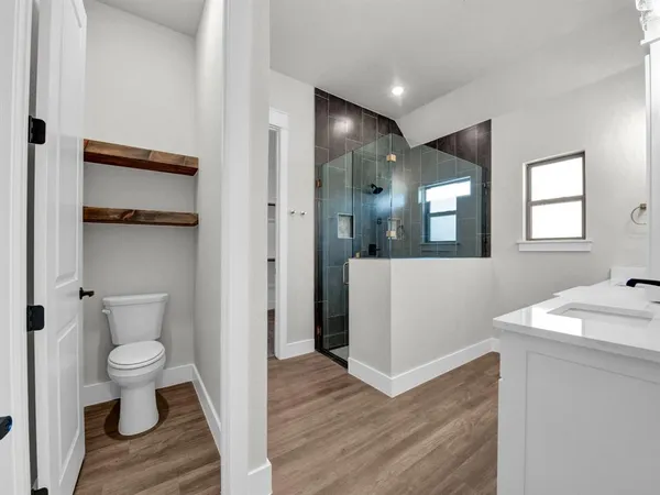 a view of bathroom with a toilet sink and a mirror