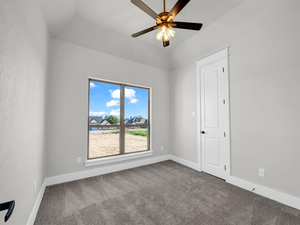 3025 West Frk Way Springtown, TX 76082 - Photo 19 of 26 an empty room with windows and fan