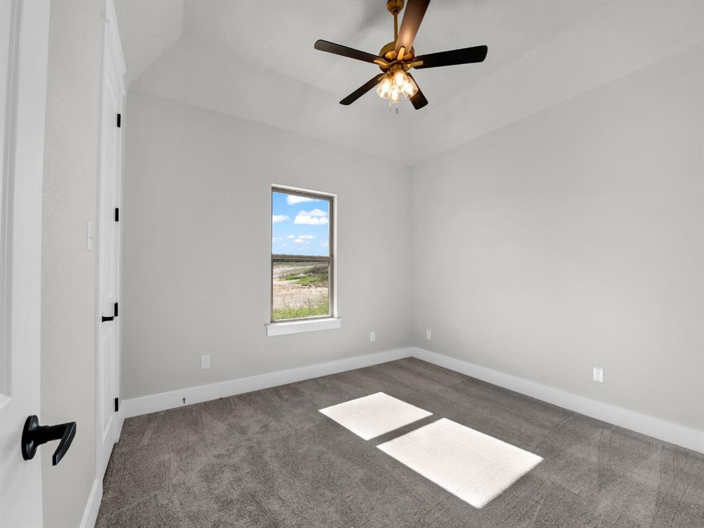 3025 West Frk Way Springtown, TX 76082 - Photo 21 of 26 an empty room with a window and a fan