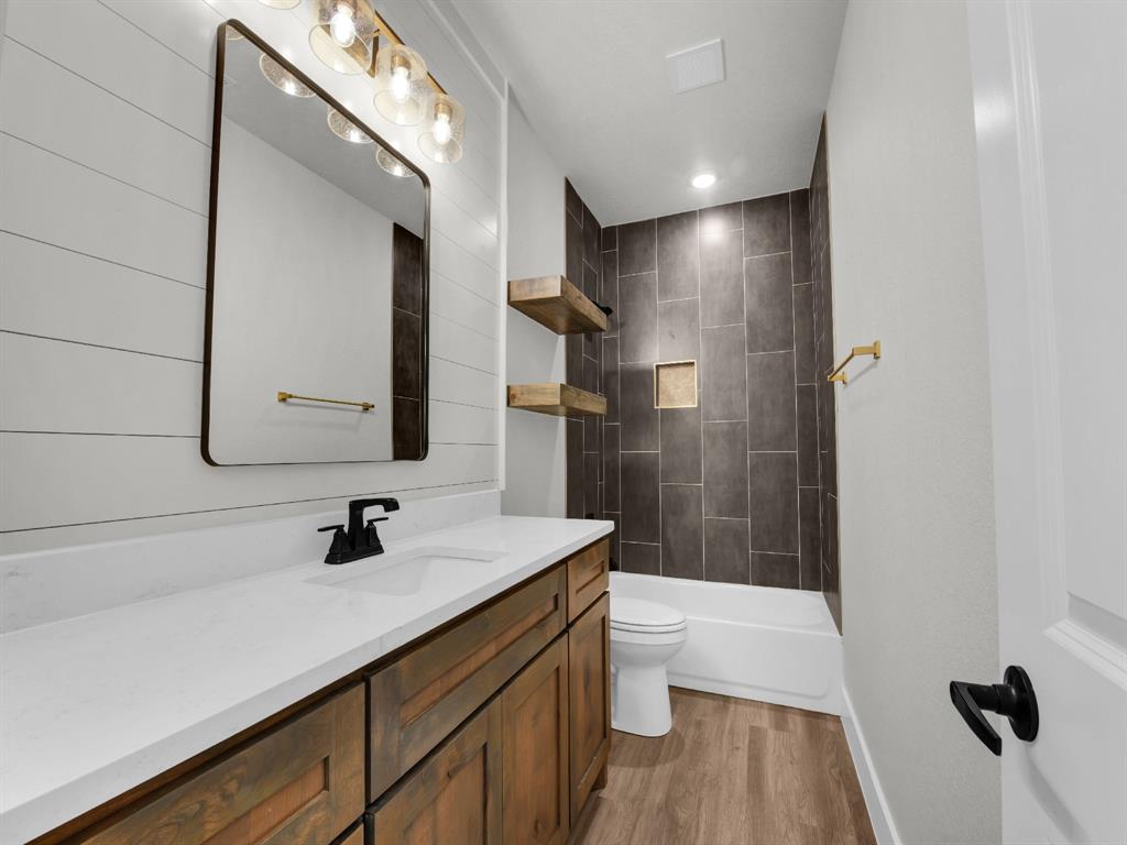 3025 West Frk Way Springtown, TX 76082 - Photo 22 of 26 a bathroom with a sink a toilet a mirror and shower
